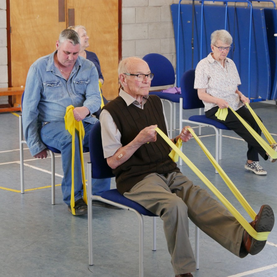 older adults doing chair based exercise